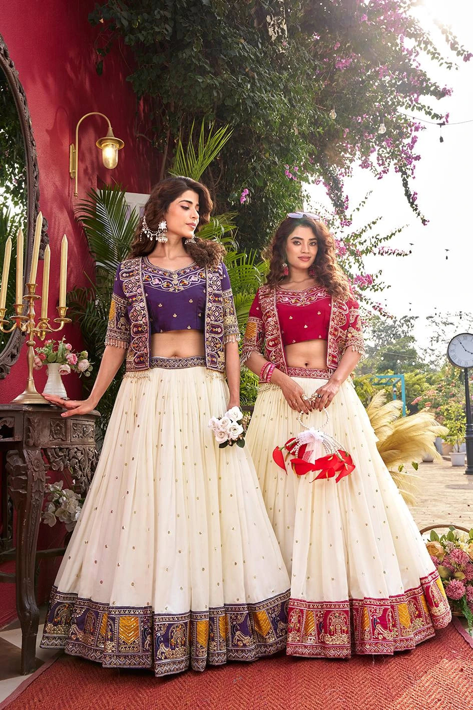 Two women in traditional outfits standing outdoors with decorative elements.